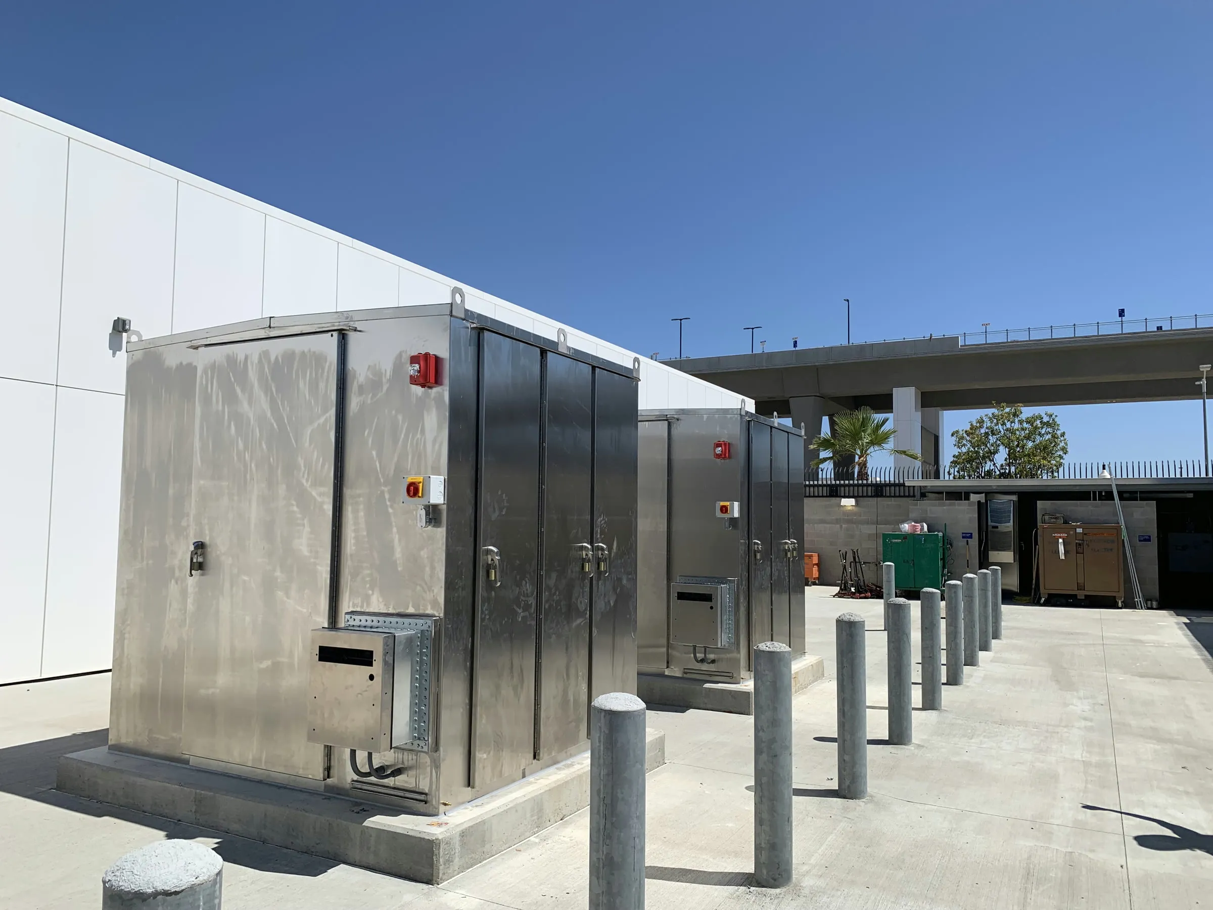 Stainless steel battery energy storage enclosure beside the transit guideway